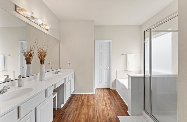 bathroom with separate shower and tub, vanity, and hardwood / wood-style flooring