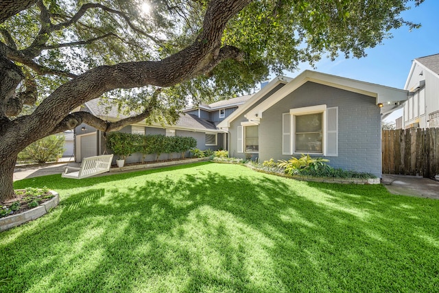 view of front of home featuring a garage and a front lawn