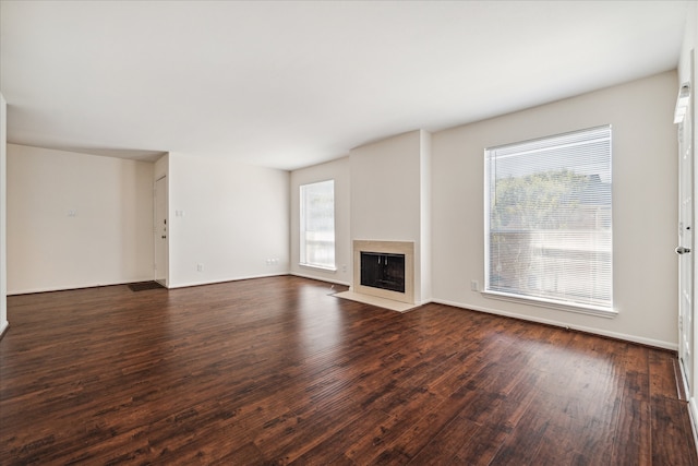 unfurnished living room featuring dark wood-type flooring