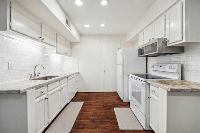 kitchen featuring white appliances, white cabinetry, dark wood-type flooring, and sink