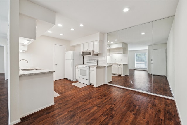 kitchen featuring white cabinetry, sink, dark wood-type flooring, and white appliances