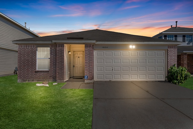 view of front of home with a lawn and a garage