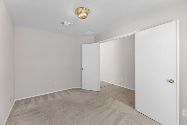 unfurnished room with light carpet