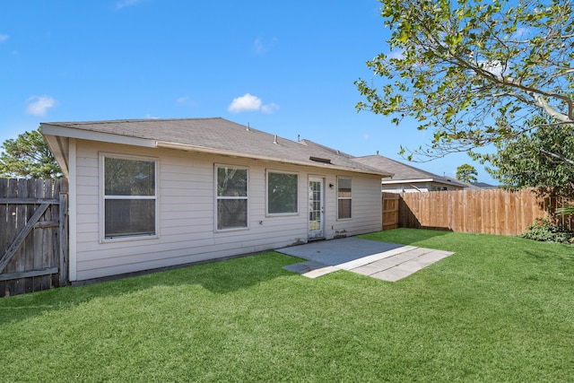 back of house featuring a yard and a patio