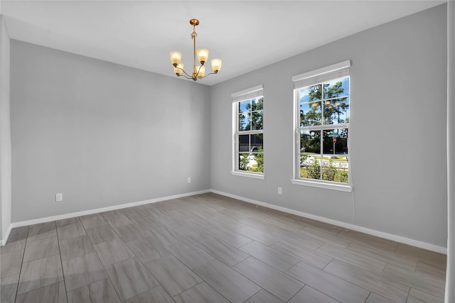 empty room featuring a chandelier