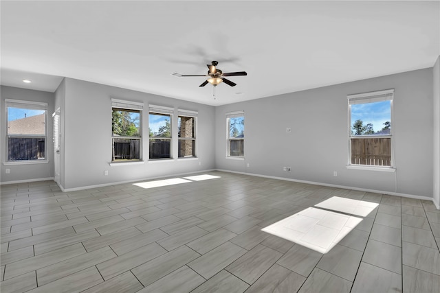 unfurnished room with ceiling fan and light wood-type flooring