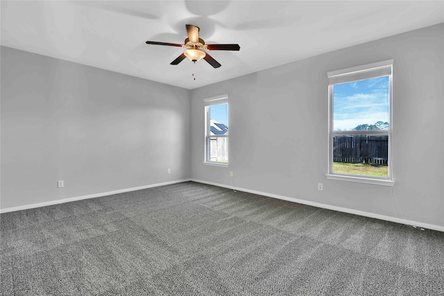 carpeted empty room featuring ceiling fan