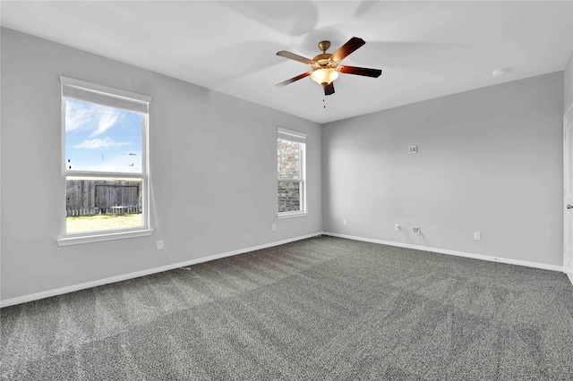 spare room featuring ceiling fan and carpet floors