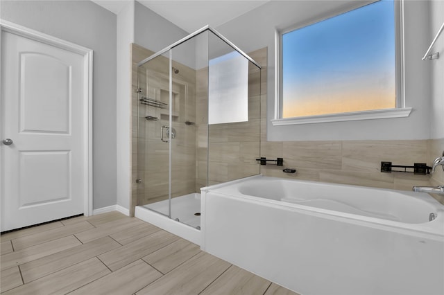 bathroom with shower with separate bathtub