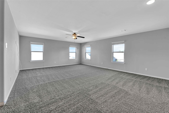 unfurnished room featuring ceiling fan, plenty of natural light, and carpet