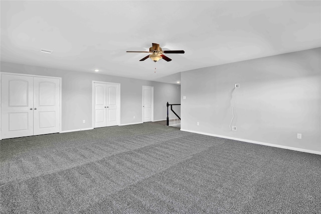 carpeted spare room with ceiling fan