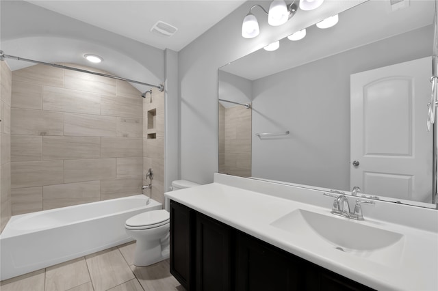 full bathroom with tile patterned flooring, vanity, toilet, and tiled shower / bath