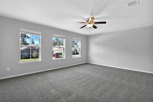 carpeted spare room with ceiling fan