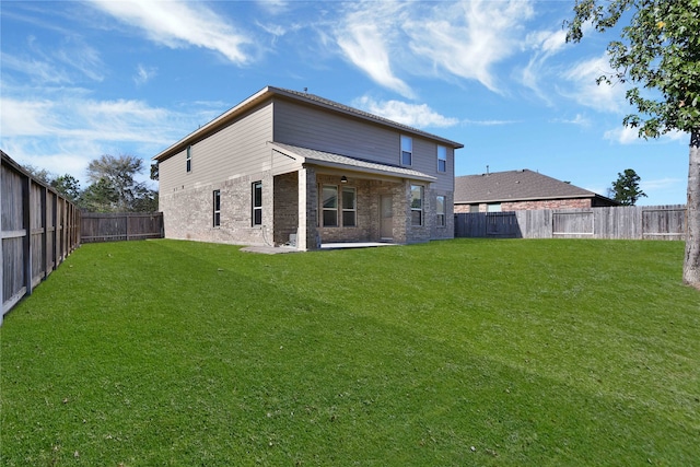 rear view of property with a yard