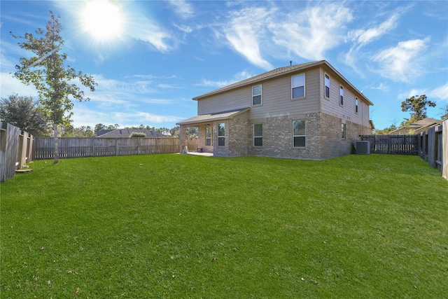 back of house with a yard and central AC unit