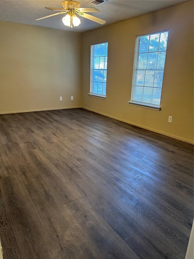 spare room with ceiling fan, dark hardwood / wood-style flooring, and a textured ceiling