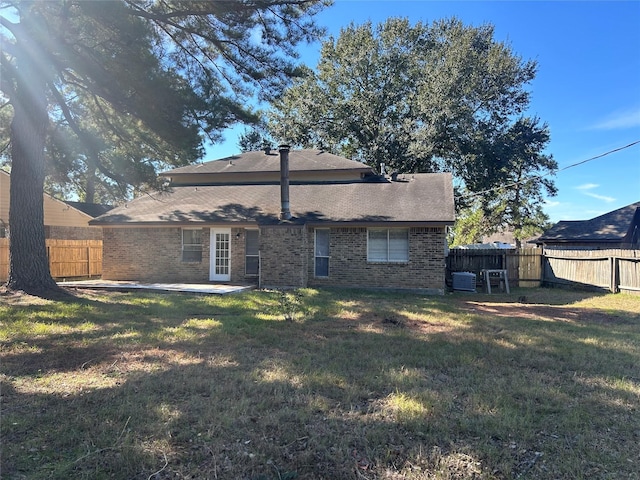 back of house with a patio area, a yard, and central AC unit