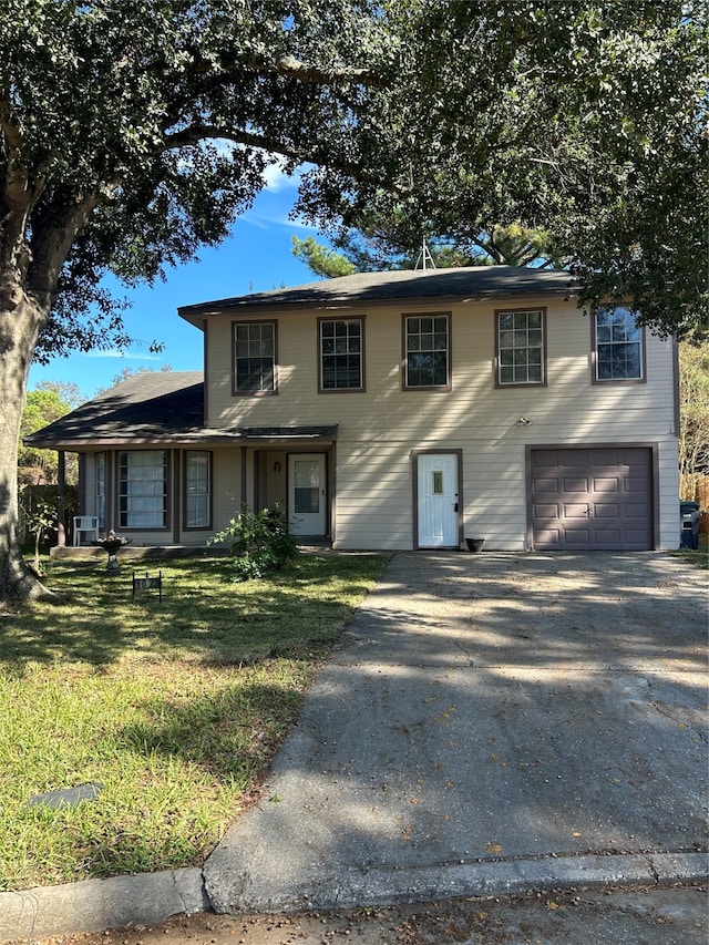 view of front facade featuring a garage and a front lawn