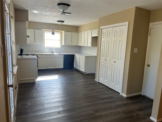 kitchen featuring dishwasher, white cabinetry, dark wood-type flooring, and sink