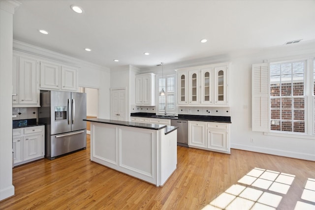 kitchen featuring white cabinets, stainless steel appliances, tasteful backsplash, and sink