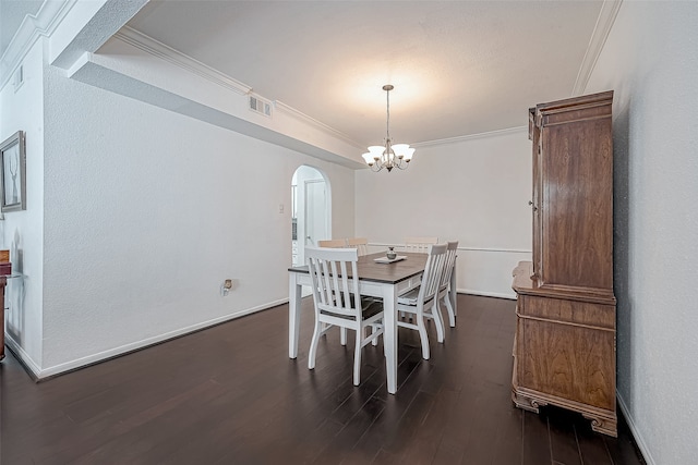 dining space featuring an inviting chandelier, ornamental molding, and dark hardwood / wood-style floors