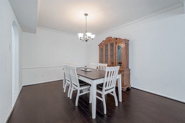 dining space with a notable chandelier, dark wood-type flooring, and ornamental molding