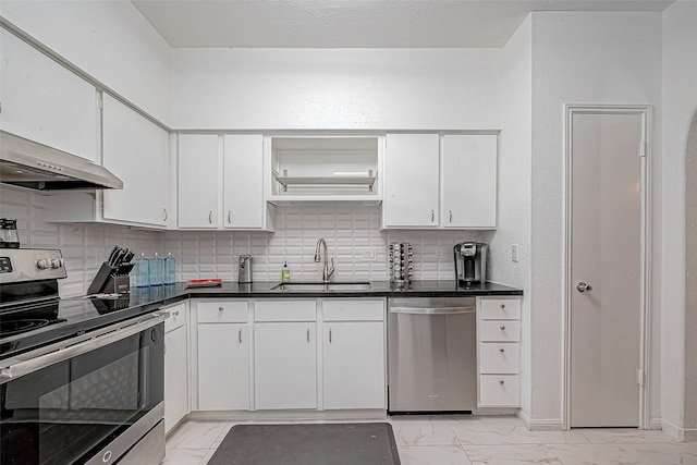 kitchen featuring sink, decorative backsplash, stainless steel appliances, and white cabinets