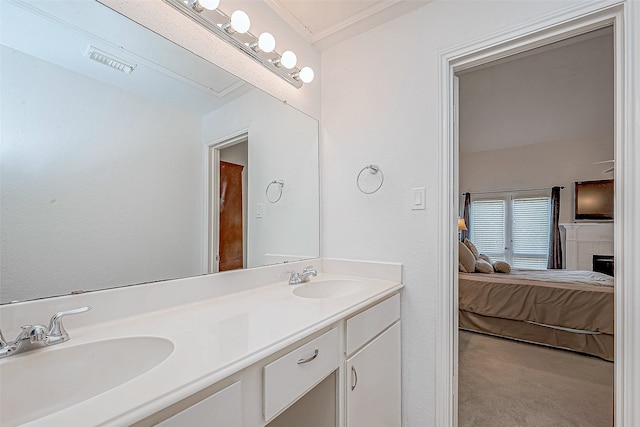 bathroom featuring ornamental molding and vanity