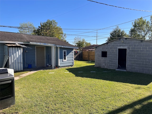 view of yard with an outbuilding and washer / clothes dryer