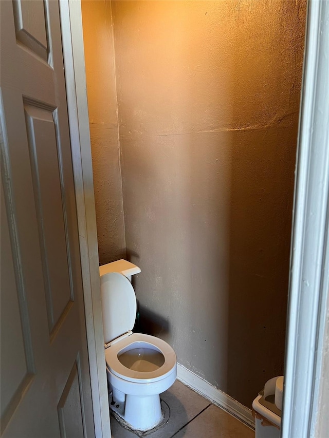 bathroom with tile patterned flooring and toilet