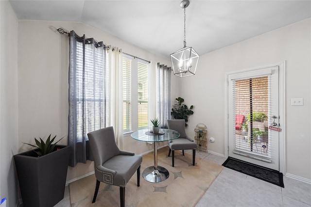 sitting room featuring light tile patterned floors, an inviting chandelier, and vaulted ceiling