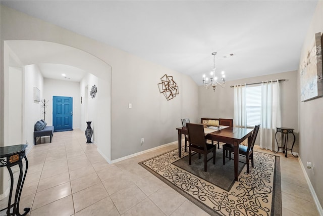 dining space featuring light tile patterned flooring and a chandelier