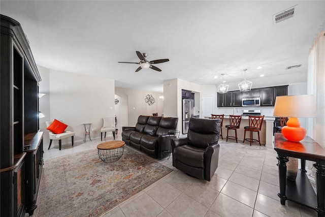 tiled living room with ceiling fan