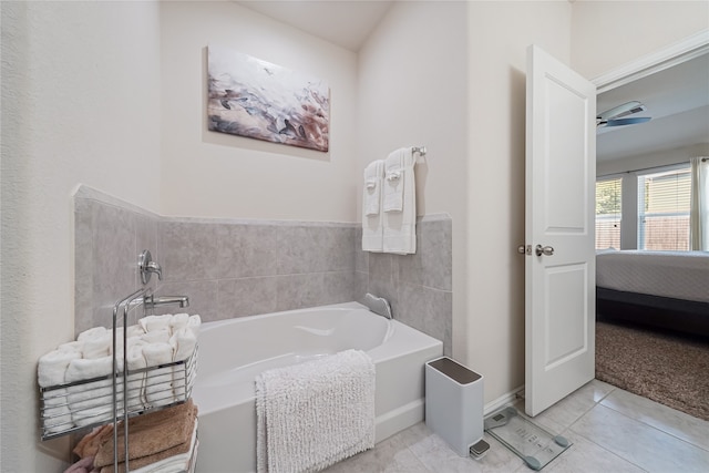 bathroom with tile patterned floors, ceiling fan, and a tub