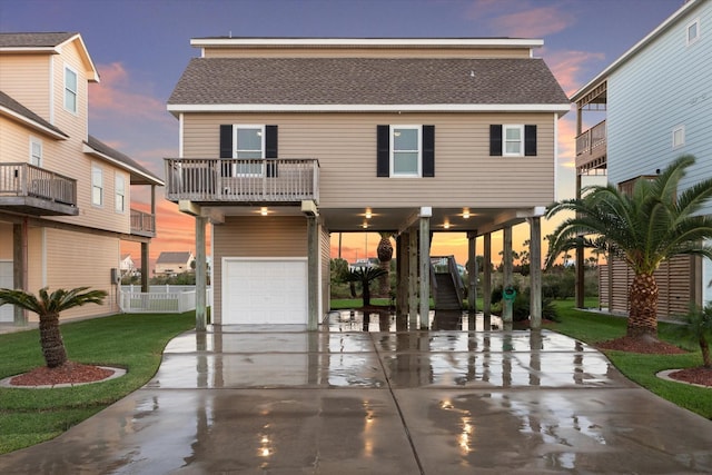 view of front of home featuring a balcony, a garage, and a carport