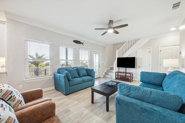 living room featuring ceiling fan, ornamental molding, a wealth of natural light, and light hardwood / wood-style flooring