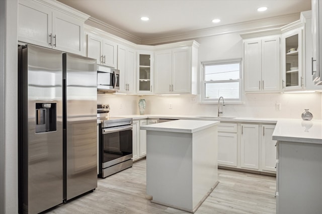 kitchen with a center island, white cabinetry, sink, and appliances with stainless steel finishes