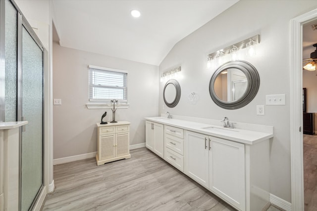 bathroom with ceiling fan, wood-type flooring, lofted ceiling, an enclosed shower, and vanity