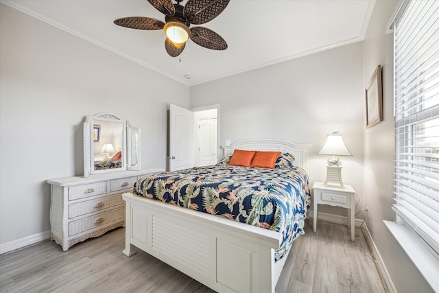 bedroom featuring light hardwood / wood-style floors, ceiling fan, and crown molding