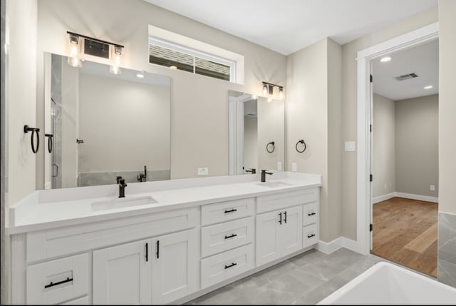 bathroom featuring vanity and a tub