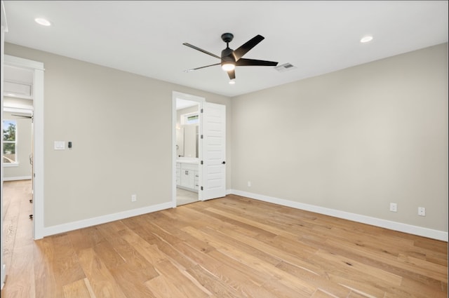 unfurnished bedroom with ceiling fan, ensuite bathroom, and light hardwood / wood-style floors