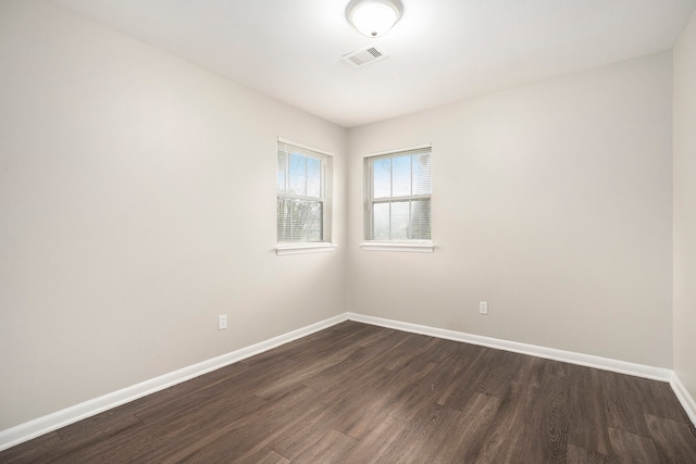 empty room with dark hardwood / wood-style floors