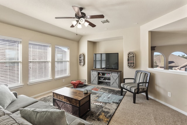 living room with ceiling fan, light carpet, and vaulted ceiling