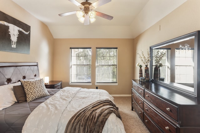 carpeted bedroom with ceiling fan, lofted ceiling, and multiple windows