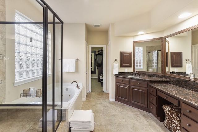 bathroom featuring vanity and plus walk in shower