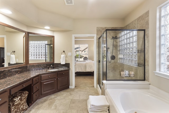 bathroom with vanity and plus walk in shower