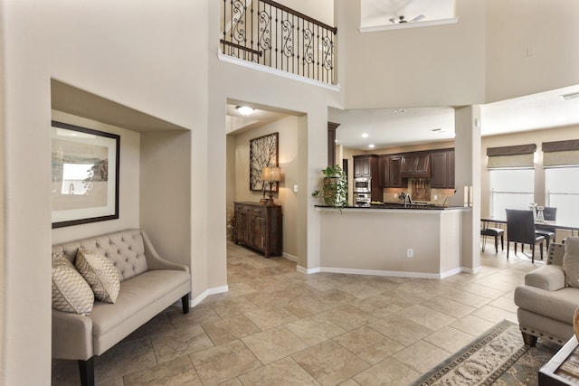 interior space featuring a high ceiling and sink