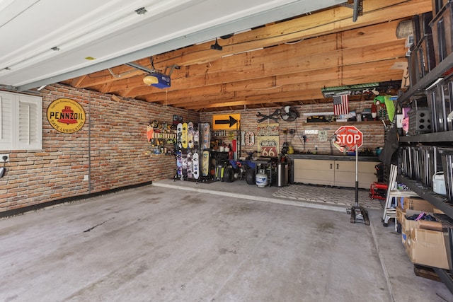 garage with a workshop area and a garage door opener