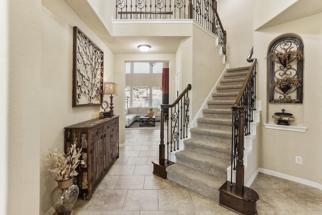 tiled entryway with a towering ceiling