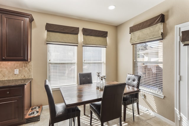 dining room with a wealth of natural light and light tile patterned floors